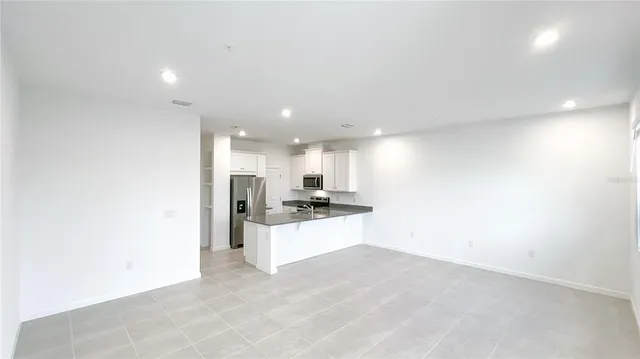 a view of a kitchen with a sink and a refrigerator