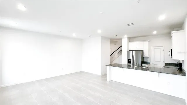 a kitchen with stainless steel appliances a sink and a refrigerator