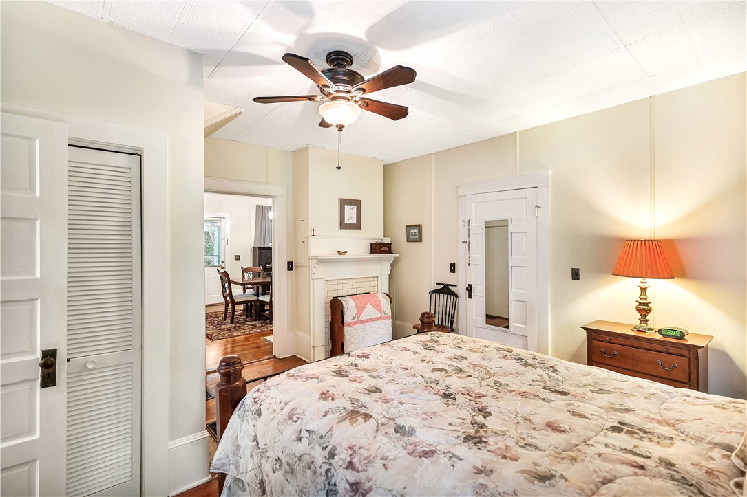 205 West Mauldin Street Walhalla, SC 29691 - Photo 14 of 43 A comforting bedroom with classic hardwood flooring extends to an adjacent dining area, and the laundry room.