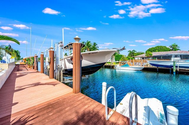 a bathroom with a tub a sink and a large mirror