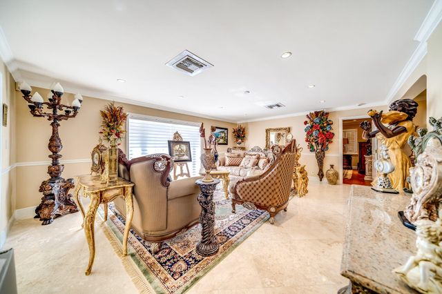 a living room with furniture a piano and a floor to ceiling window