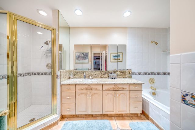 a view of a dining room with furniture and a chandelier