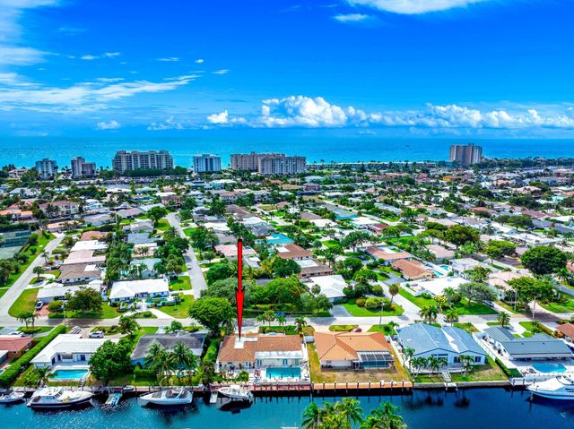 a view of a house with swimming pool and sitting area