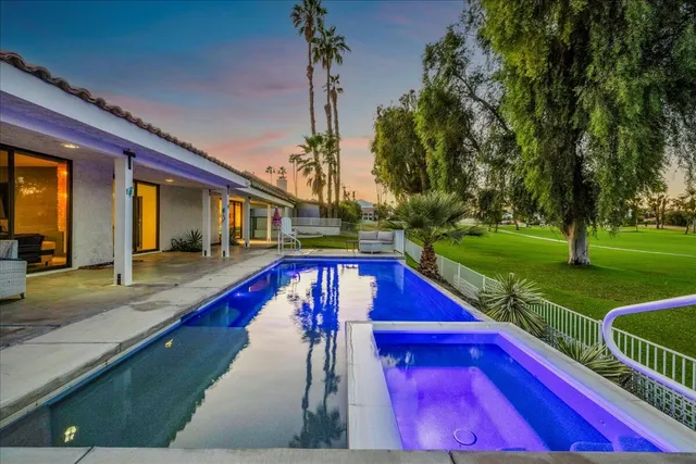 a view of swimming pool with seating area and furniture