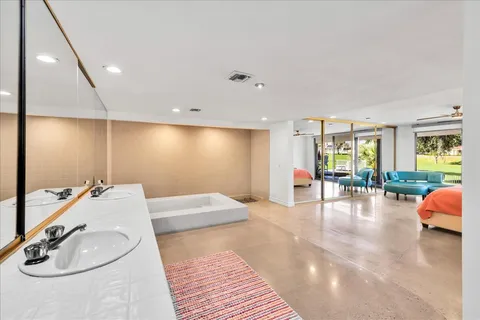 a view of a house with swimming pool and sitting area