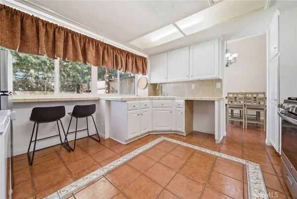 a open kitchen with granite countertop a sink cabinets and appliances