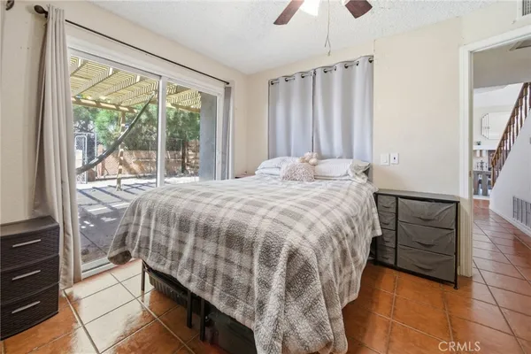 a bed sitting in a bedroom next to a window