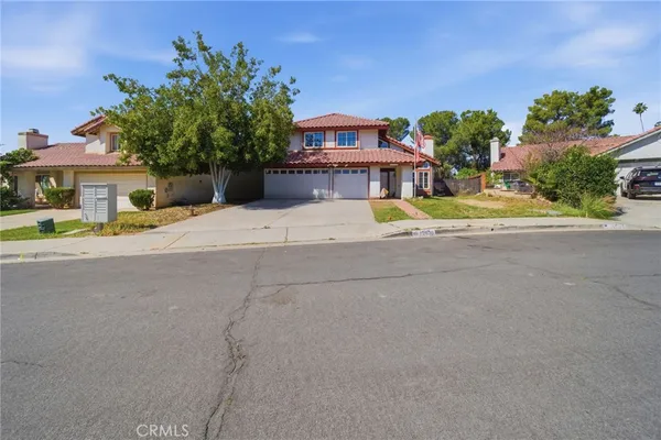 a house with a yard and a large parking space