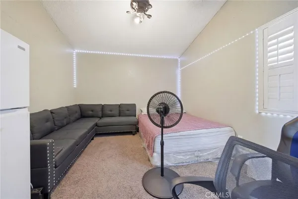 a living room with furniture a couch and a window