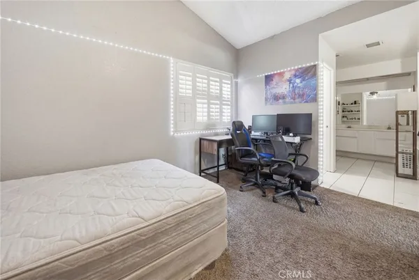 a bed room with a bed and a chair