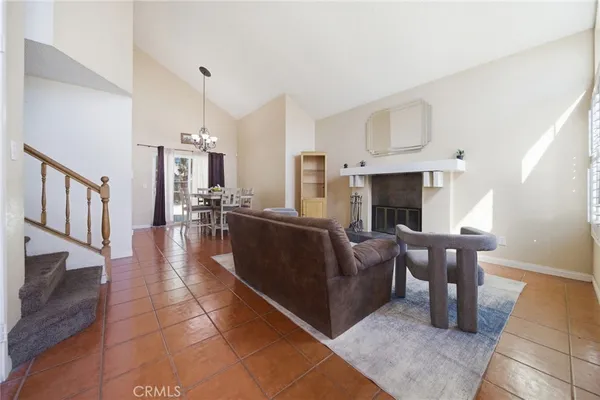 a living room with furniture a fireplace and a table