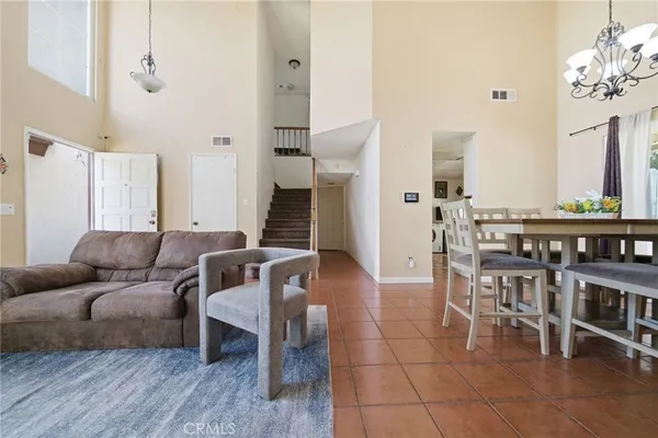 a living room with furniture a dining table and a fireplace