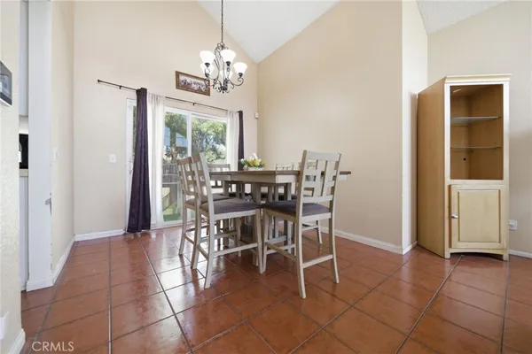 a view of a dining room with furniture and a chandelier