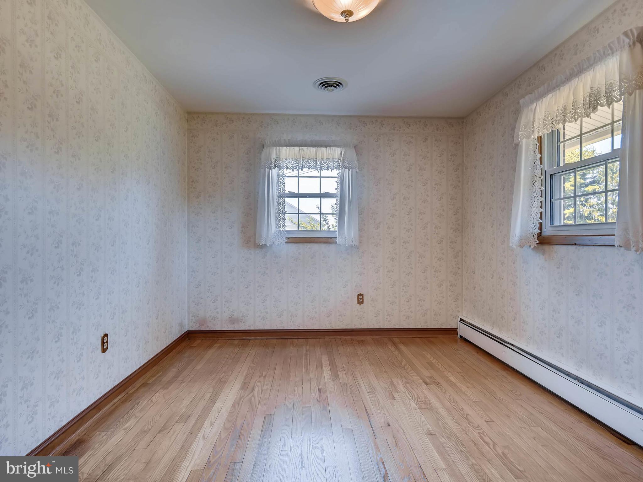 2626 Pleasantville Road Fallston, MD 21047 - Photo 11 of 29 an empty room with wooden floor and windows