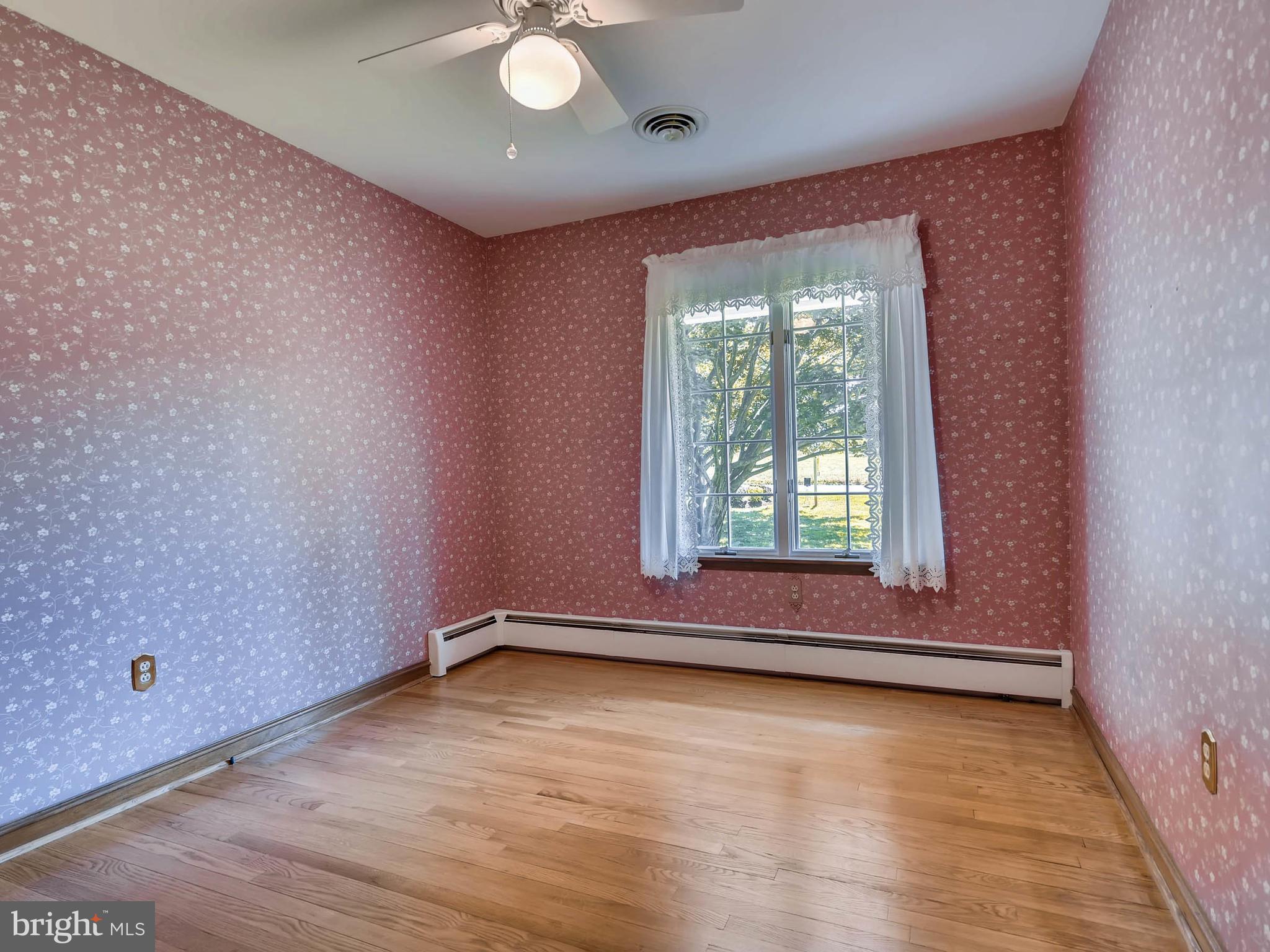 2626 Pleasantville Road Fallston, MD 21047 - Photo 13 of 29 a view of an empty room with wooden floor and a window