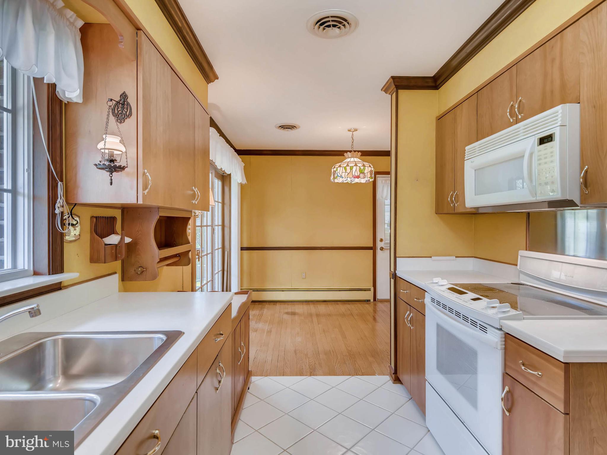2626 Pleasantville Road Fallston, MD 21047 - Photo 7 of 29 a kitchen with stainless steel appliances granite countertop a sink and a refrigerator