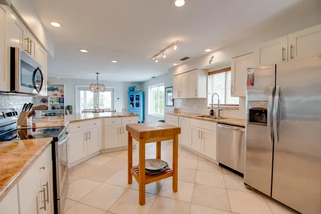a kitchen with a refrigerator a sink and cabinets