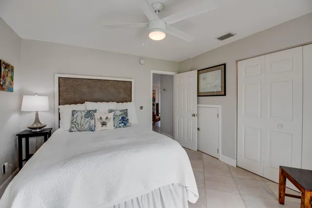 a bedroom with a bed and a lamp