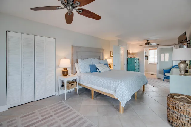 a bed room with a bed and a chandelier