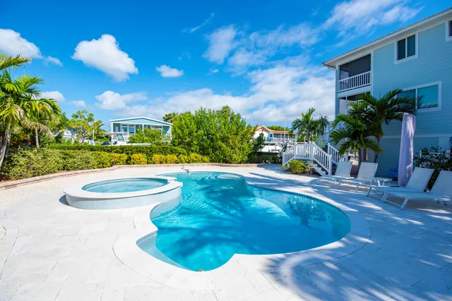 a swimming pool with outdoor seating and yard