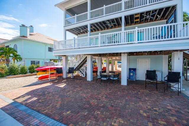 a bedroom with furniture and a large window