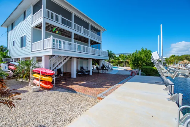 a view of a porch with furniture and a yard