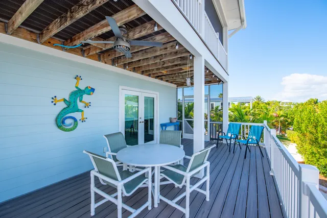 an aerial view of a house with a yard and a wooden deck