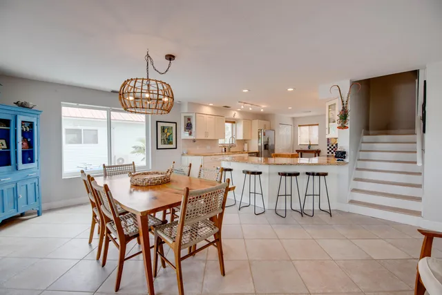 a dining room with a wooden table and chairs