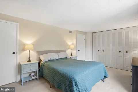 a bedroom with a bed and a lamp