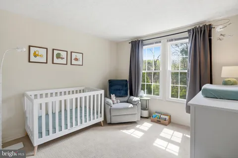 a bedroom with furniture and a large window