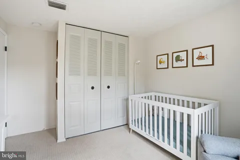 a view of a bedroom with wooden floor