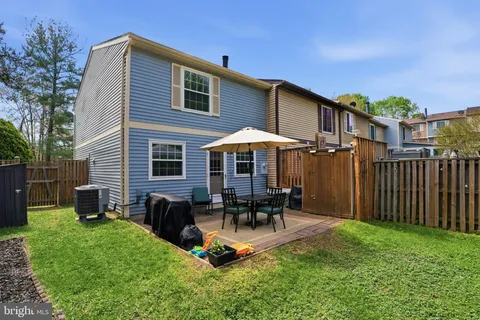 a backyard of a house with table and chairs