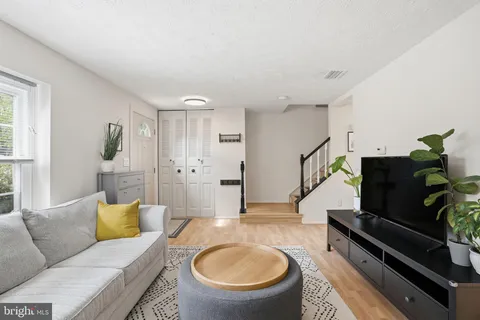 a living room with furniture and a piano