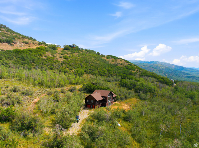 5404 Mountain View Road Coalville, UT 84017 - Photo 39 of 50 Hillside property with a multi-level structure, a dark-toned exterior, and a reddish-brown roof