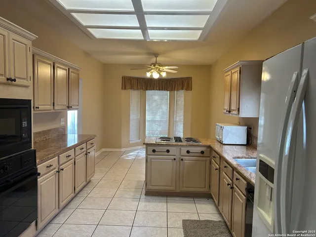 a kitchen with stainless steel appliances a stove sink and cabinets