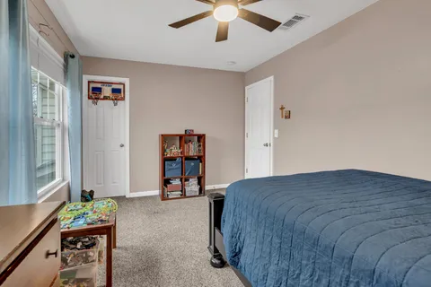 a bedroom with a bed and a book shelf