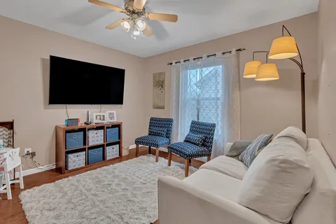 a living room with furniture and a flat screen tv