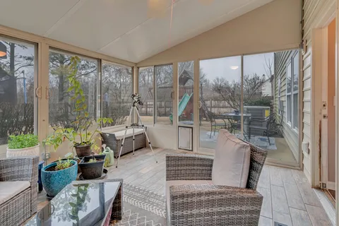 a living room with furniture and large windows