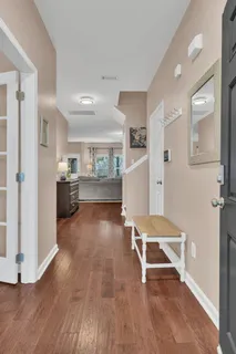 a room with furniture and view of kitchen