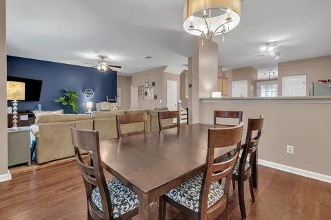 a view of a dining room with furniture and wooden floor