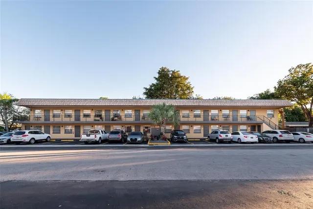 a city street lined with lots of buildings and cars