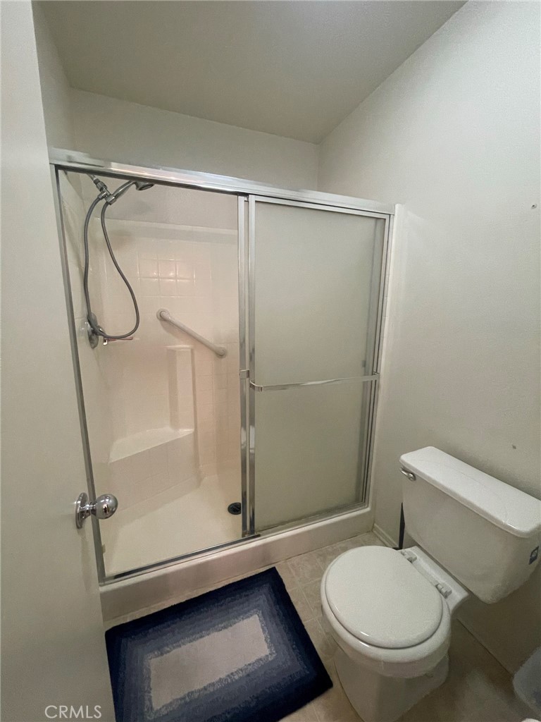 965 Hardwick Avenue Beaumont, CA 92223 - Photo 12 of 19 a white toilet sitting next to a shower