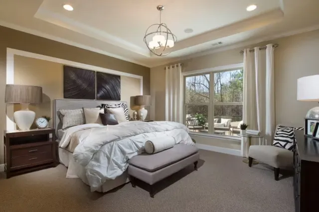 a spacious bedroom with bed and a large window