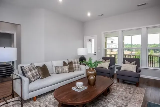 a living room with furniture and a large window