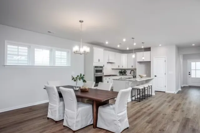 a view of a dining room with furniture and wooden floor