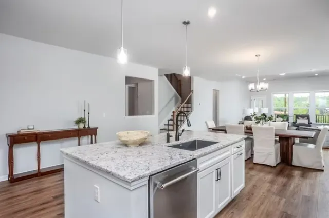 a kitchen with sink and view of living room