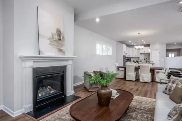 a living room with furniture fireplace and window