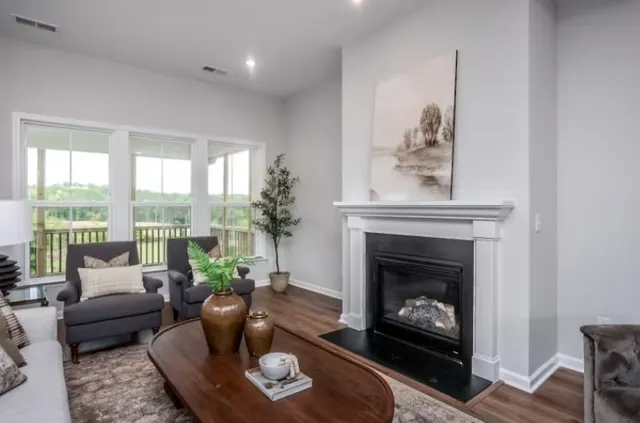 a living room with furniture and a fireplace
