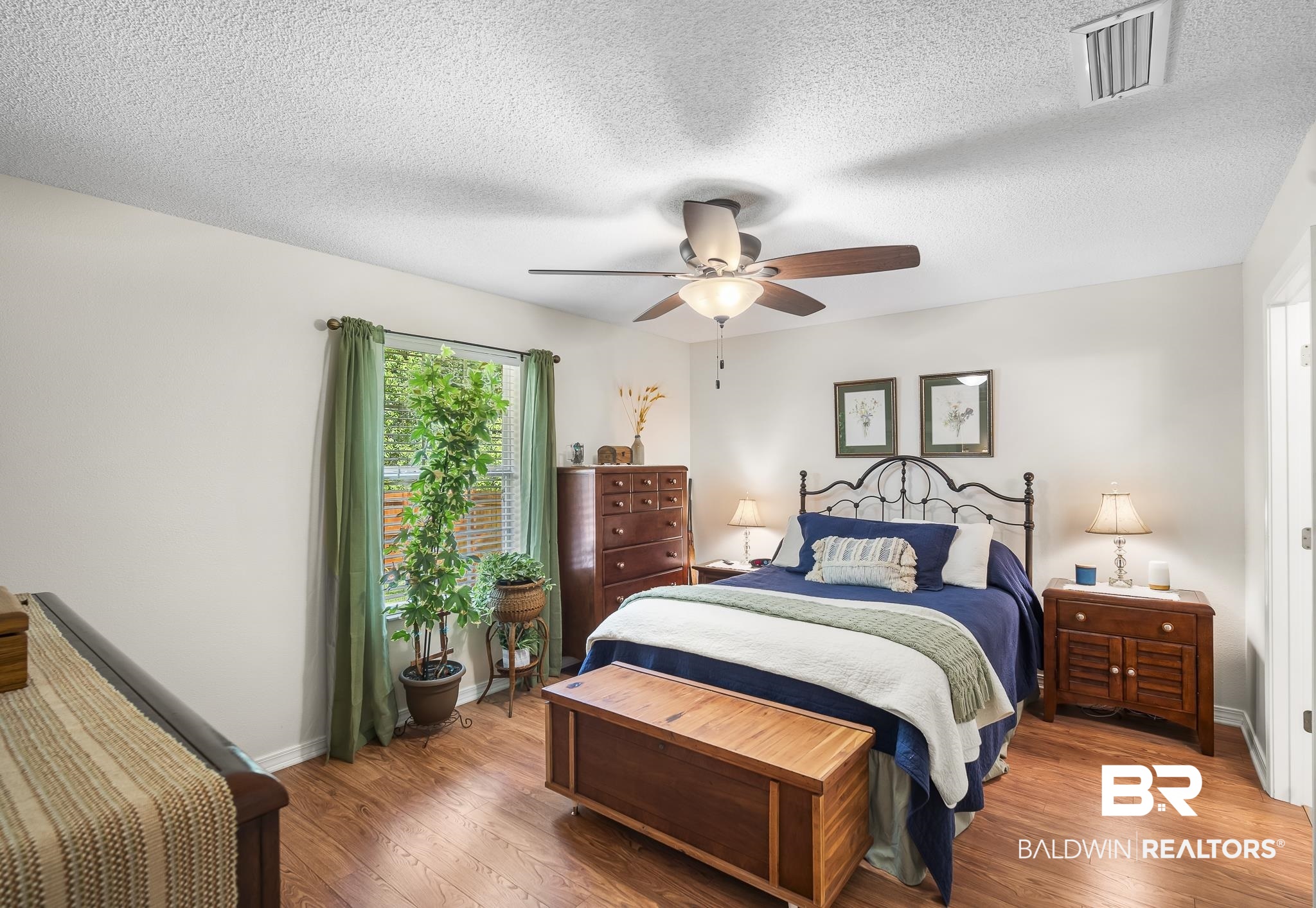 1802 South Bay Street Foley, AL 36535 - Photo 15 of 30 Bedroom with wood finished floors, a textured ceiling, baseboards, and a ceiling fan
