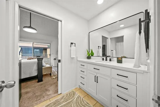 a spacious bathroom with a granite countertop sink mirror and a